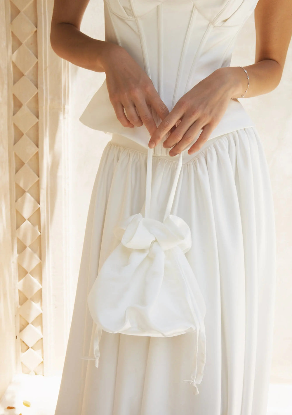Modern bridal bag designed to complement pearl earrings, wedding gowns and bridal reception looks