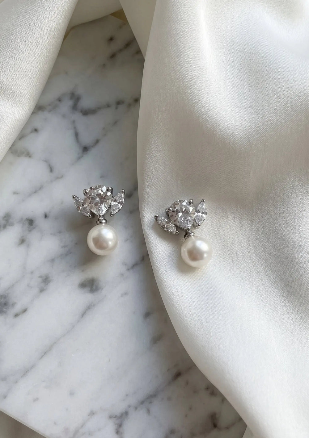 Maris statement bridal drop earrings in silver with pear cut crystals and pearl detailing by Lolaknight