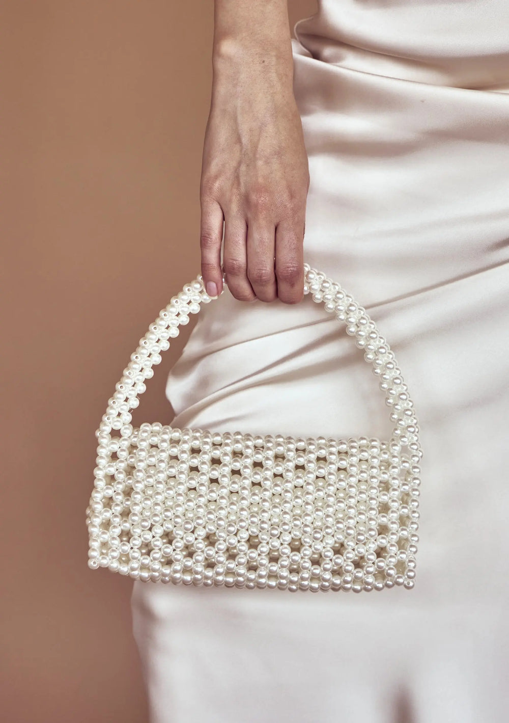 Modern bridal bag designed to complement pearl earrings, wedding gowns and bridal reception looks