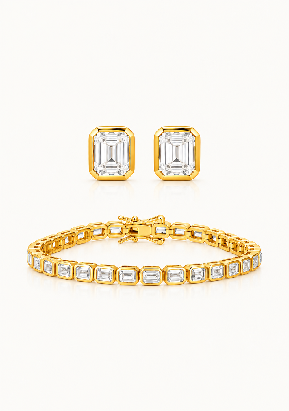 A gold jewelry set featuring a bracelet, matching stud earrings, and a ring, all adorned with emerald-cut clear stones on a clean white background.