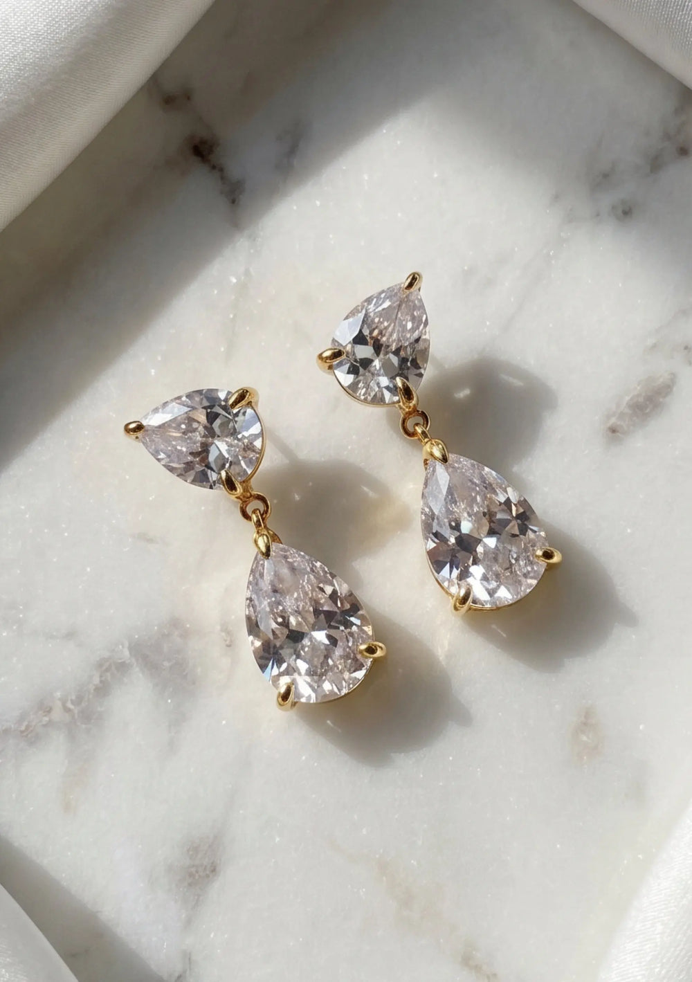 Aura crystal bridal earrings in 18K gold featuring pear shaped cubic zirconia crystals by Lolaknight