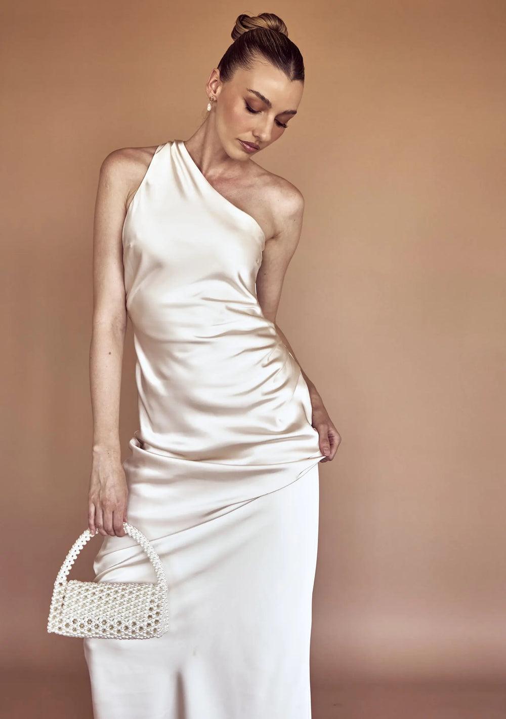 Modern bridal bag designed to complement pearl earrings, wedding gowns and bridal reception looks