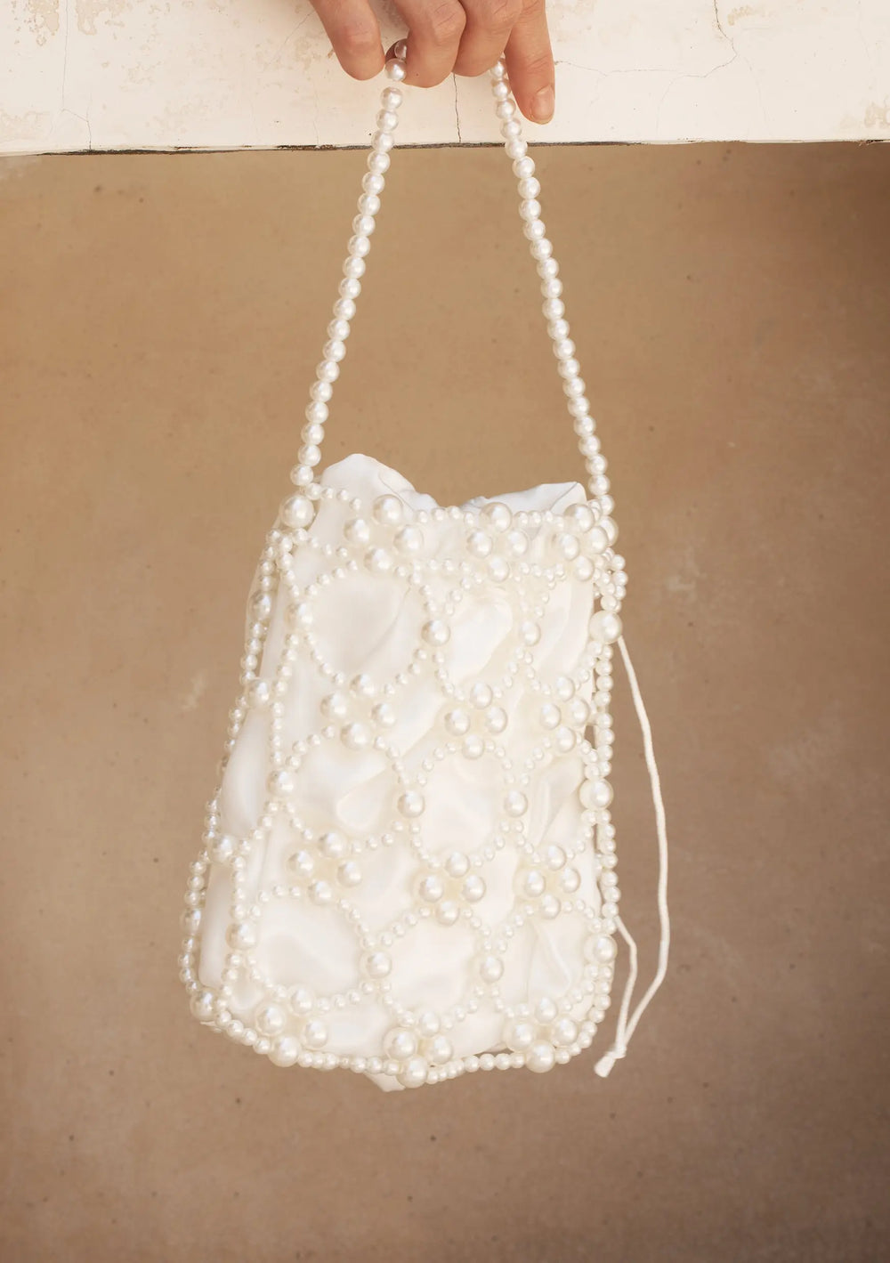 Modern bridal bag designed to complement pearl earrings, wedding gowns and bridal reception looks
