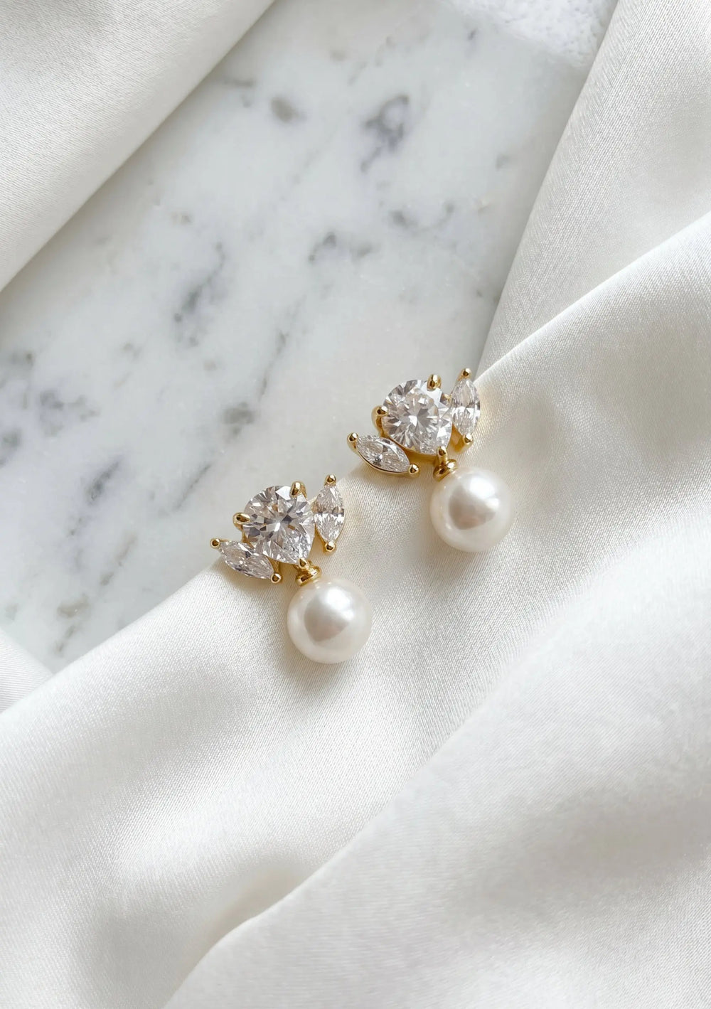 Maris statement bridal drop earrings in 18K gold with pear cut crystals and pearl detailing by Lolaknight