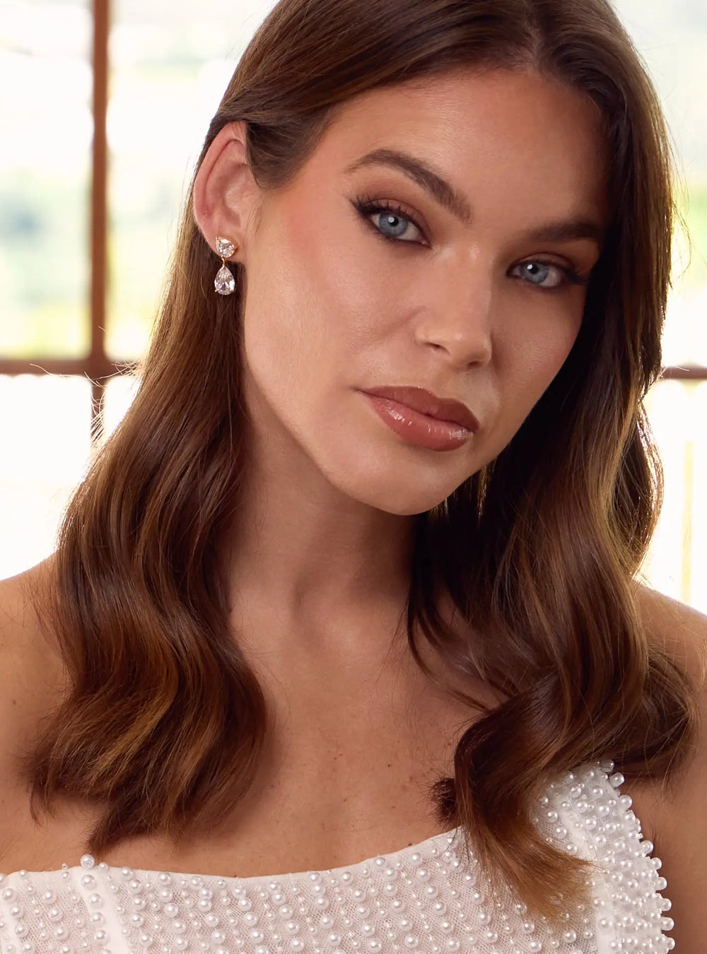 Gold crystal wedding earrings with elegant pear cut stones for brides and bridal celebrations