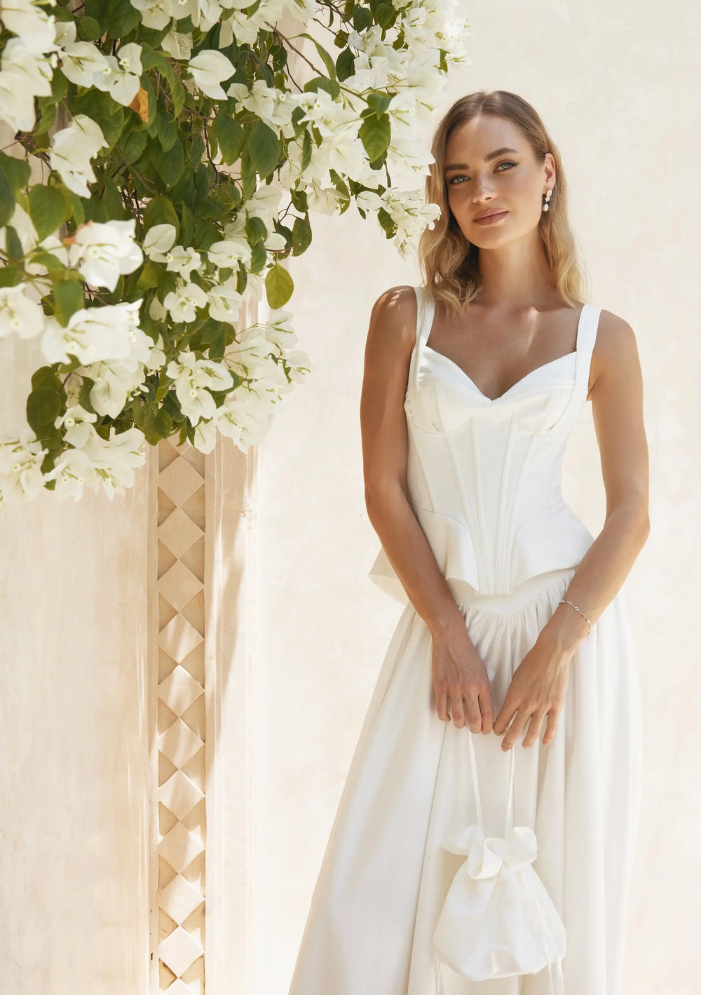 Modern bridal bag designed to complement pearl earrings, wedding gowns and bridal reception looks