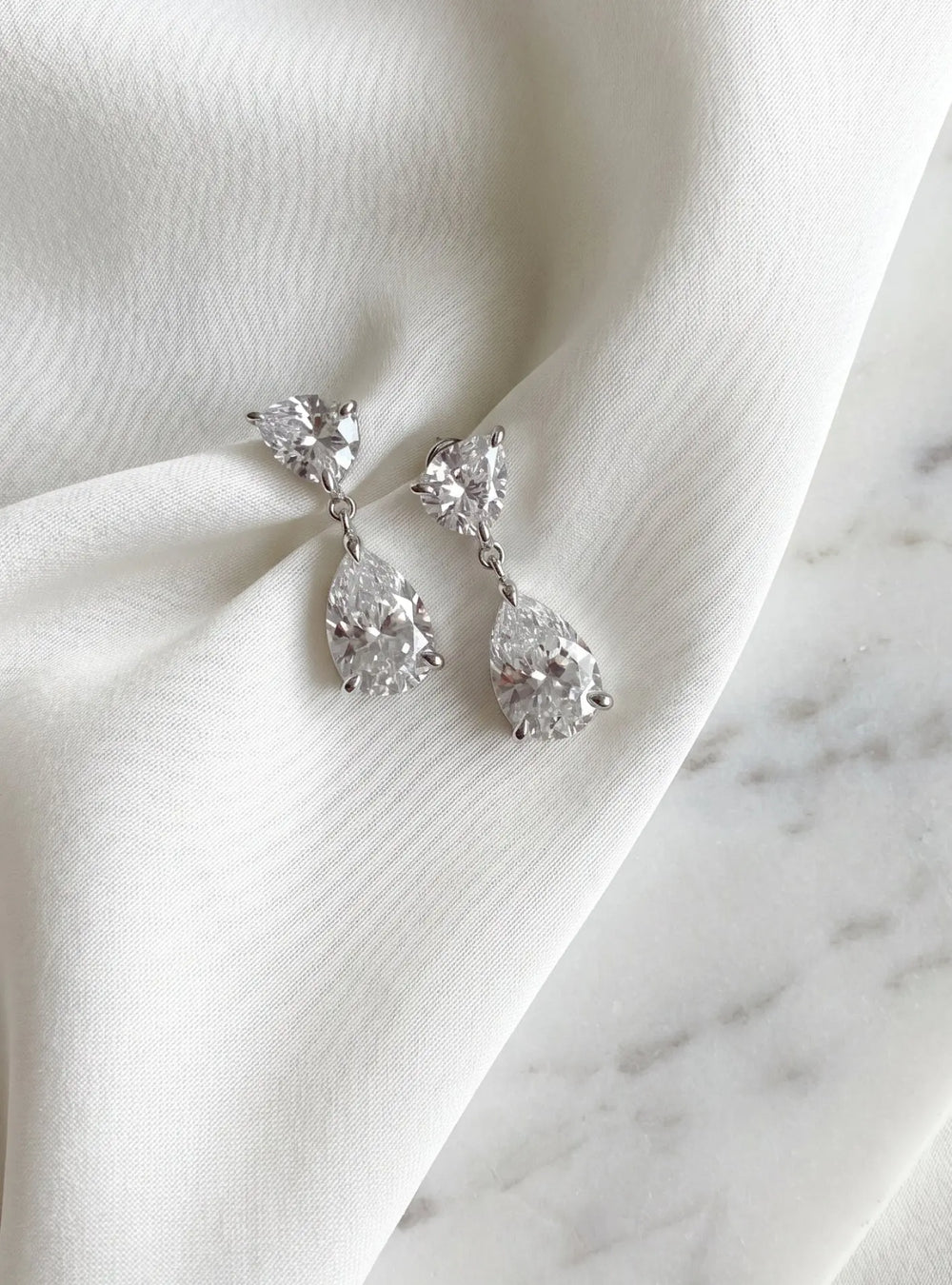 Aura crystal bridal earrings in 18K gold featuring pear shaped cubic zirconia crystals by Lolaknight