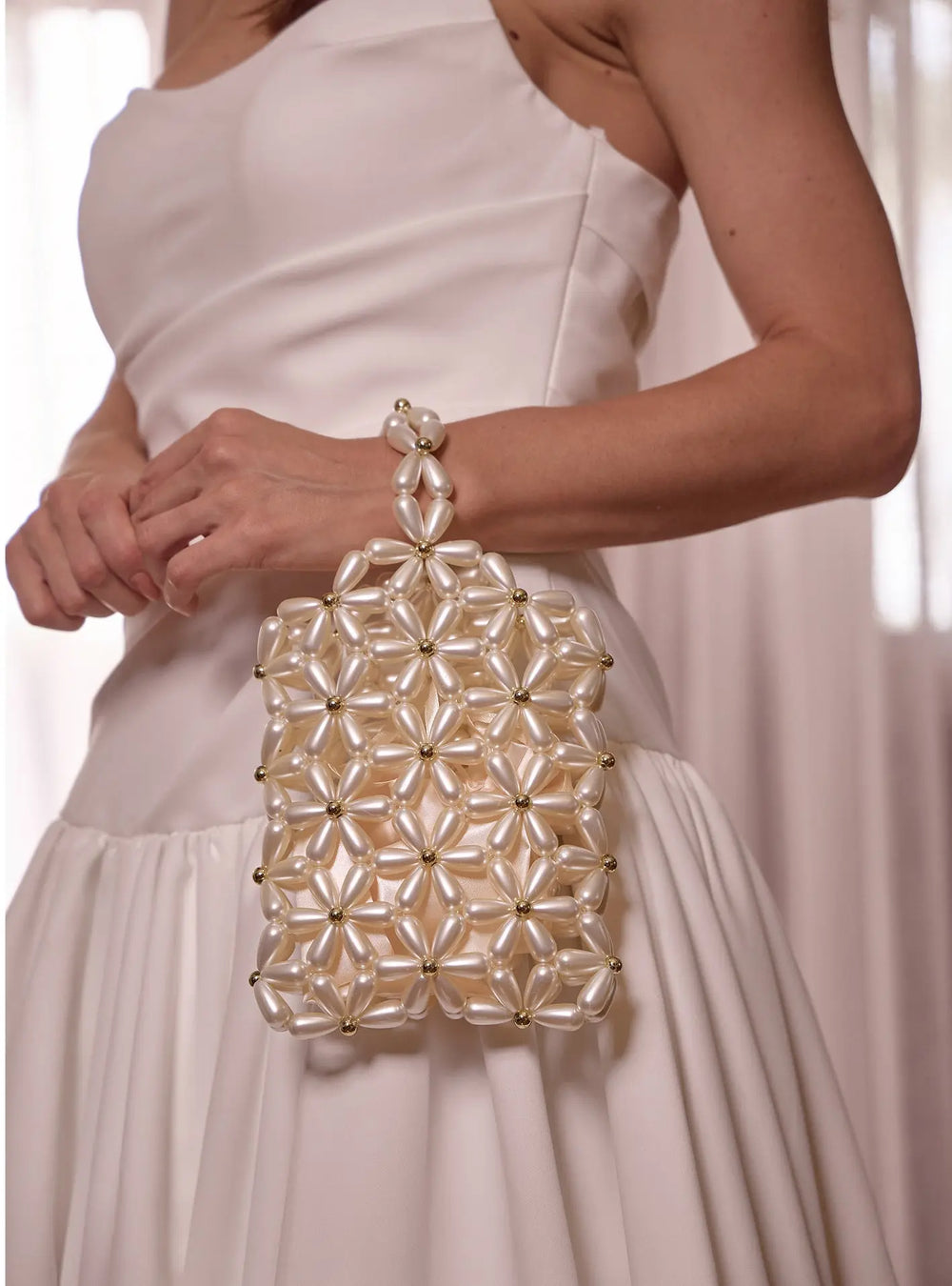 Modern bridal bag designed to complement pearl earrings, wedding gowns and bridal reception looks