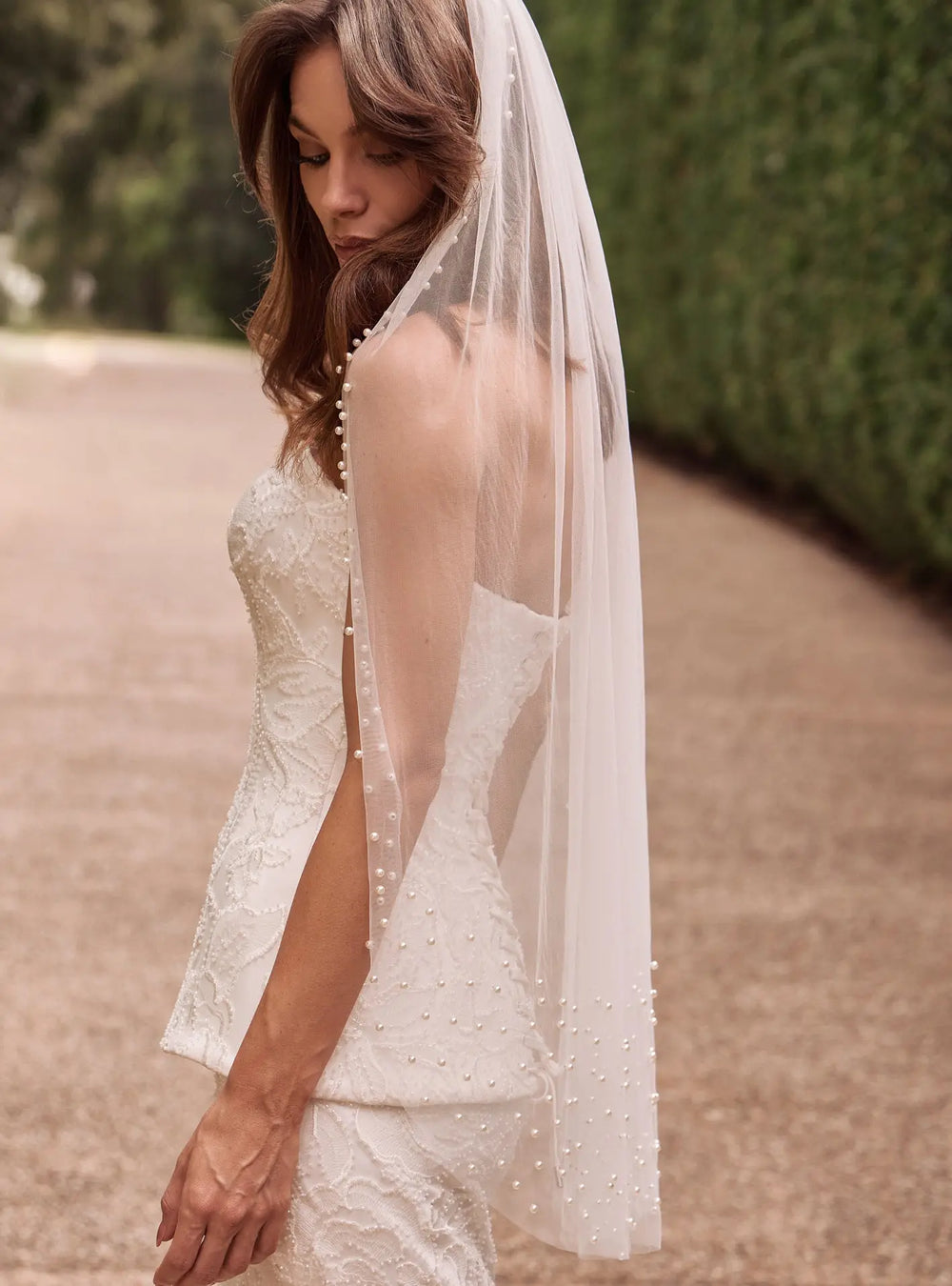 Ivory pearl cathedral veil with elegant pearl detailing for wedding ceremonies and bridal receptions