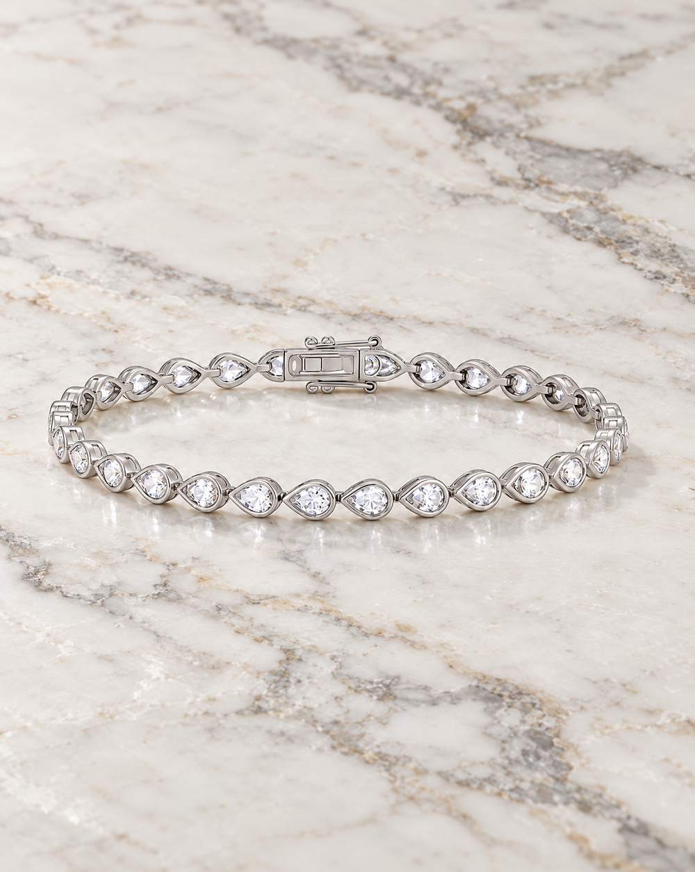 Chic silver crystal tennis bracelet for the modern bride. This is a chic pear bezel tennis bracelet.