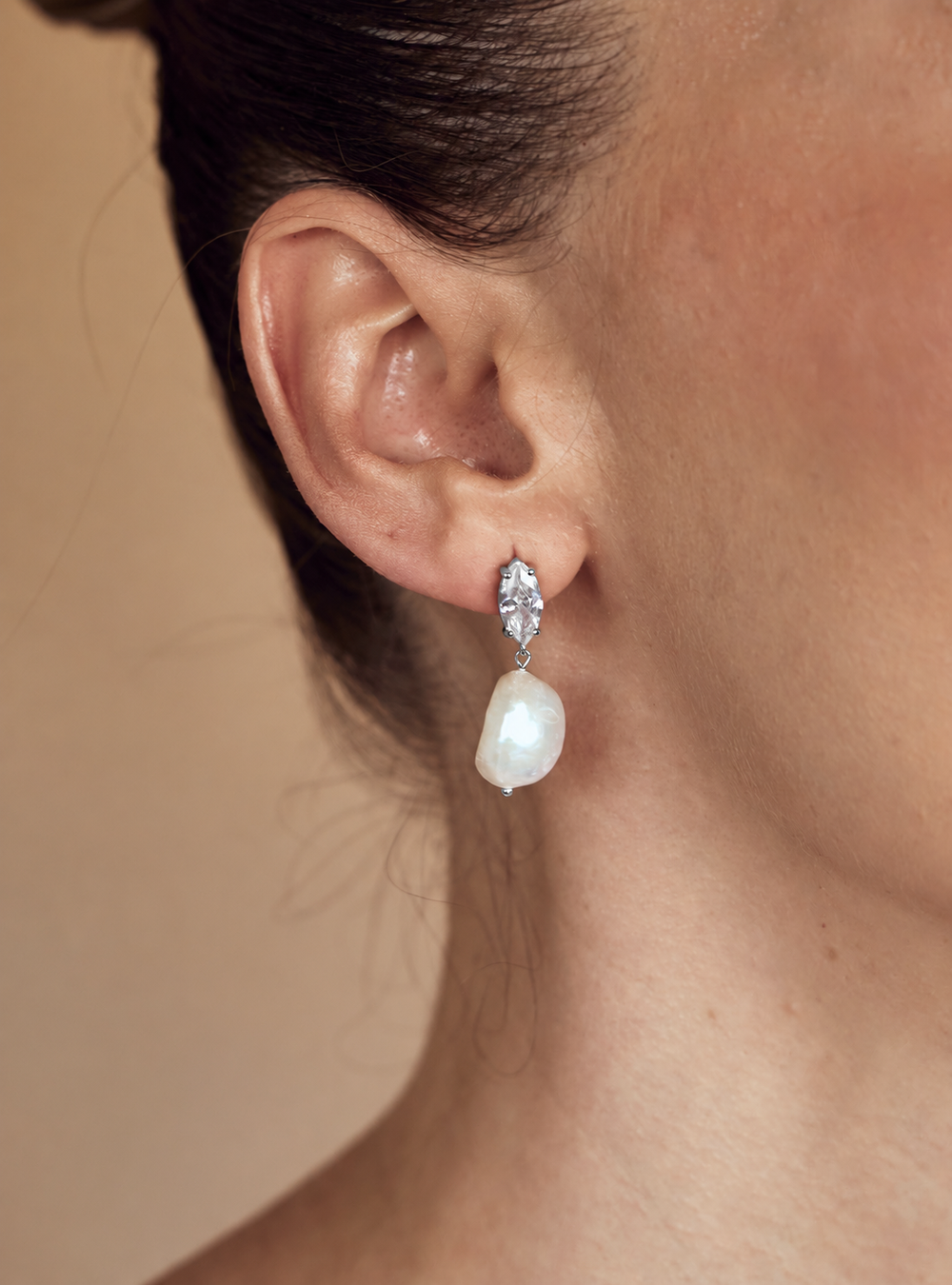 Woman wearing marquise crystal silver pearl drop bridal earrings for the modern chic bride