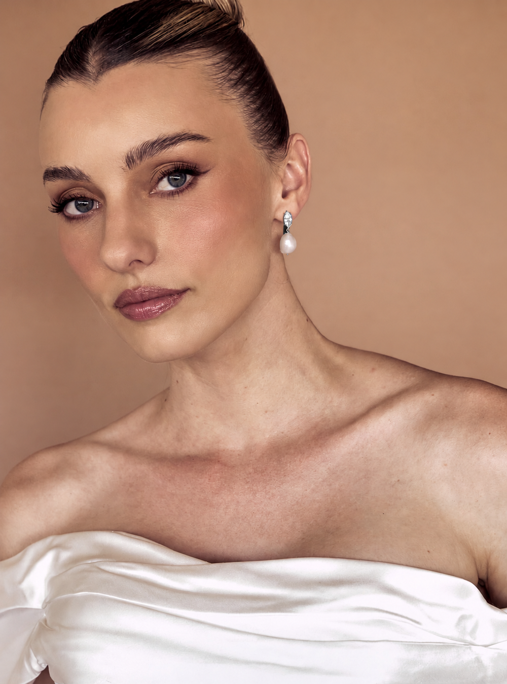 Woman wearing marquise crystal silver pearl drop bridal earrings for the modern chic bride