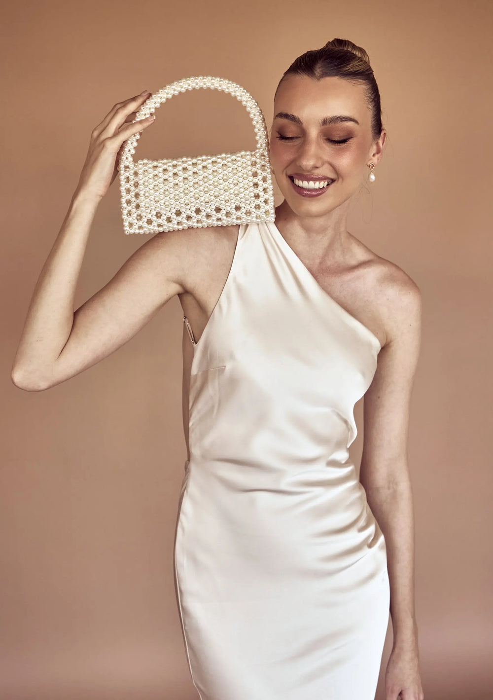 Modern bridal bag designed to complement pearl earrings, wedding gowns and bridal reception looks