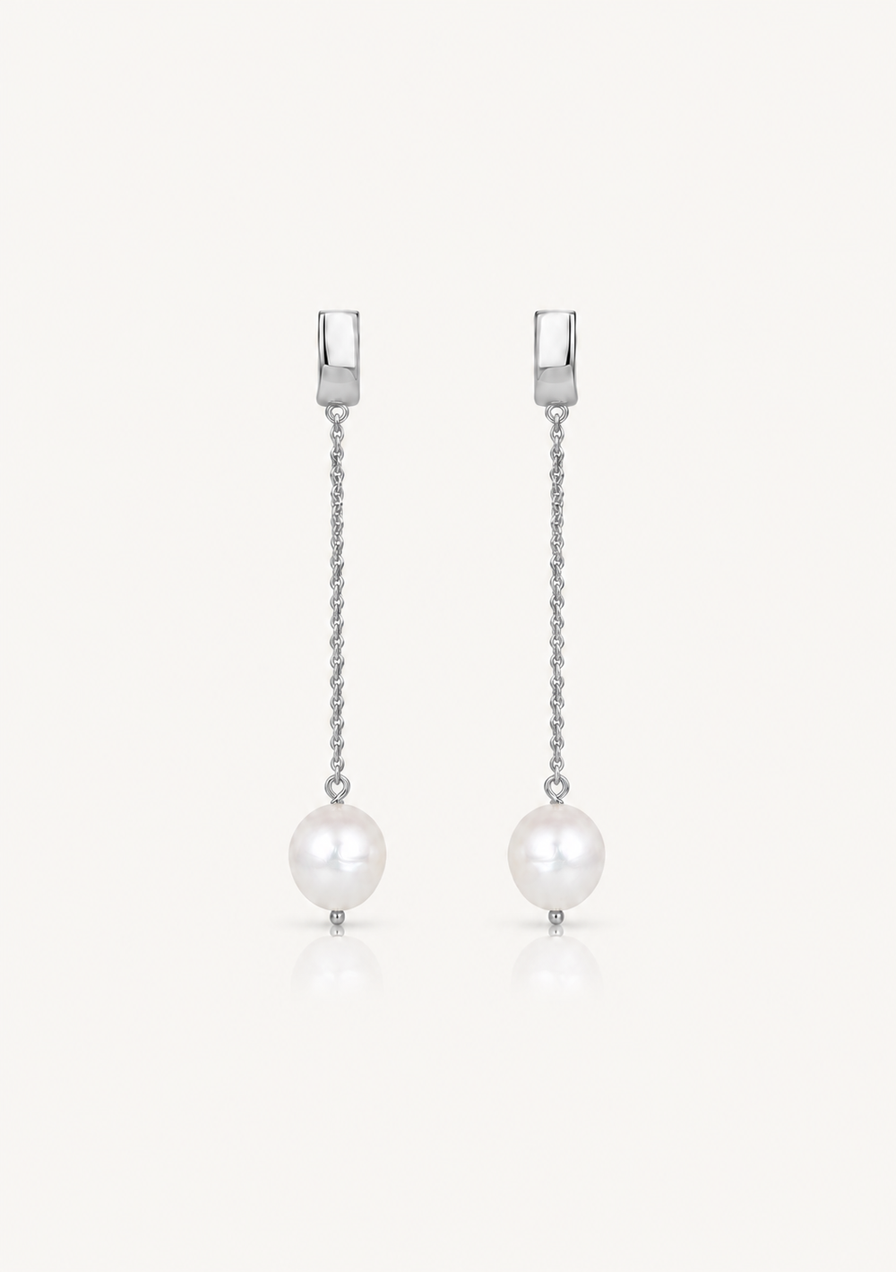A pair of silver drop earrings with a rectangular post, a delicate chain, and a dangling white pearl on a clean white background.
