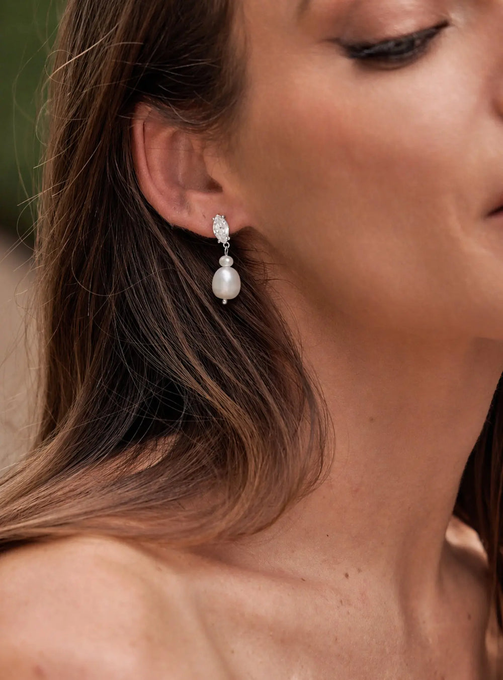Elegant silver bridal earrings featuring sparkling crystals and pearl drop detailing