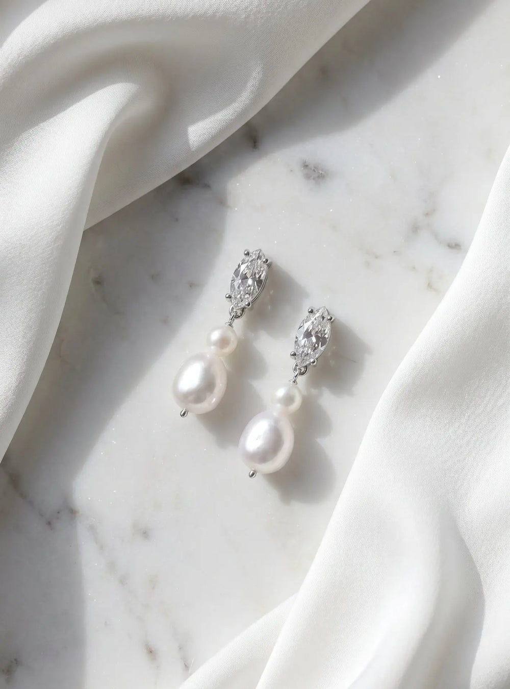 Elegant silver bridal earrings featuring sparkling crystals and pearl drop detailing