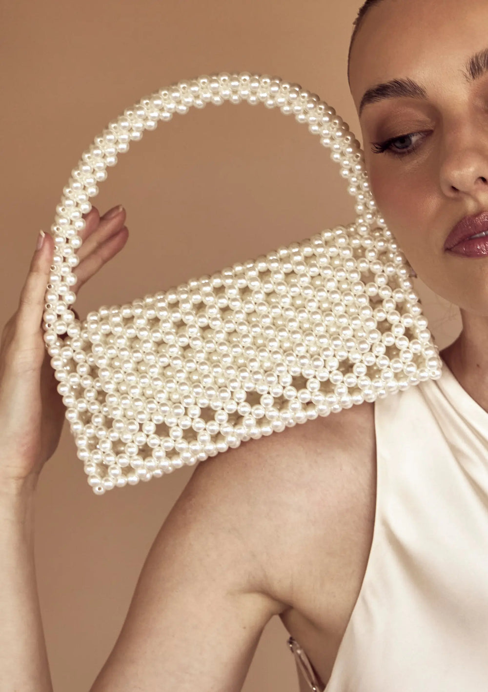 Modern bridal bag designed to complement pearl earrings, wedding gowns and bridal reception looks