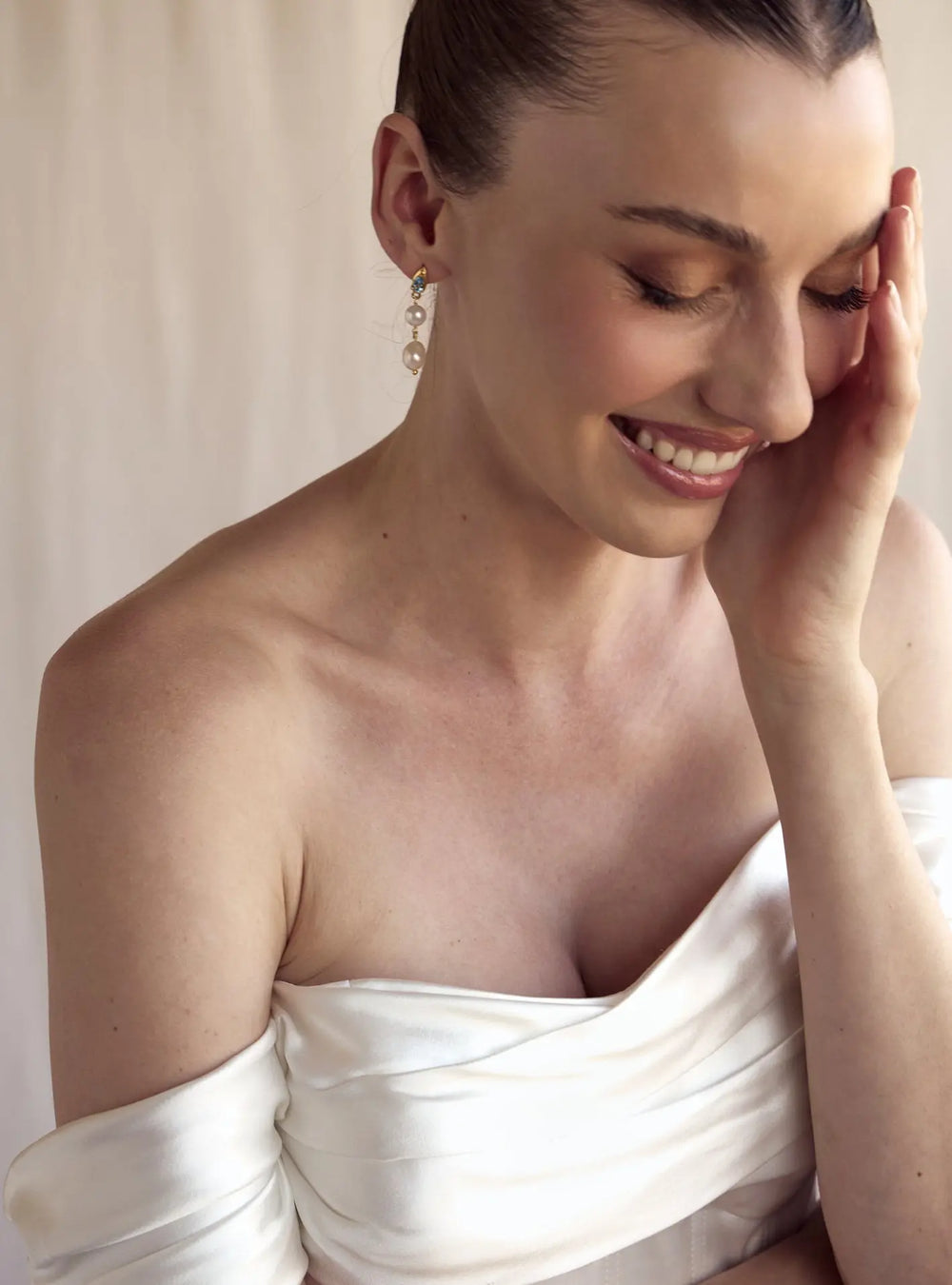 Elegant gold bridal earrings featuring sparkling crystals and pearl drop detailing